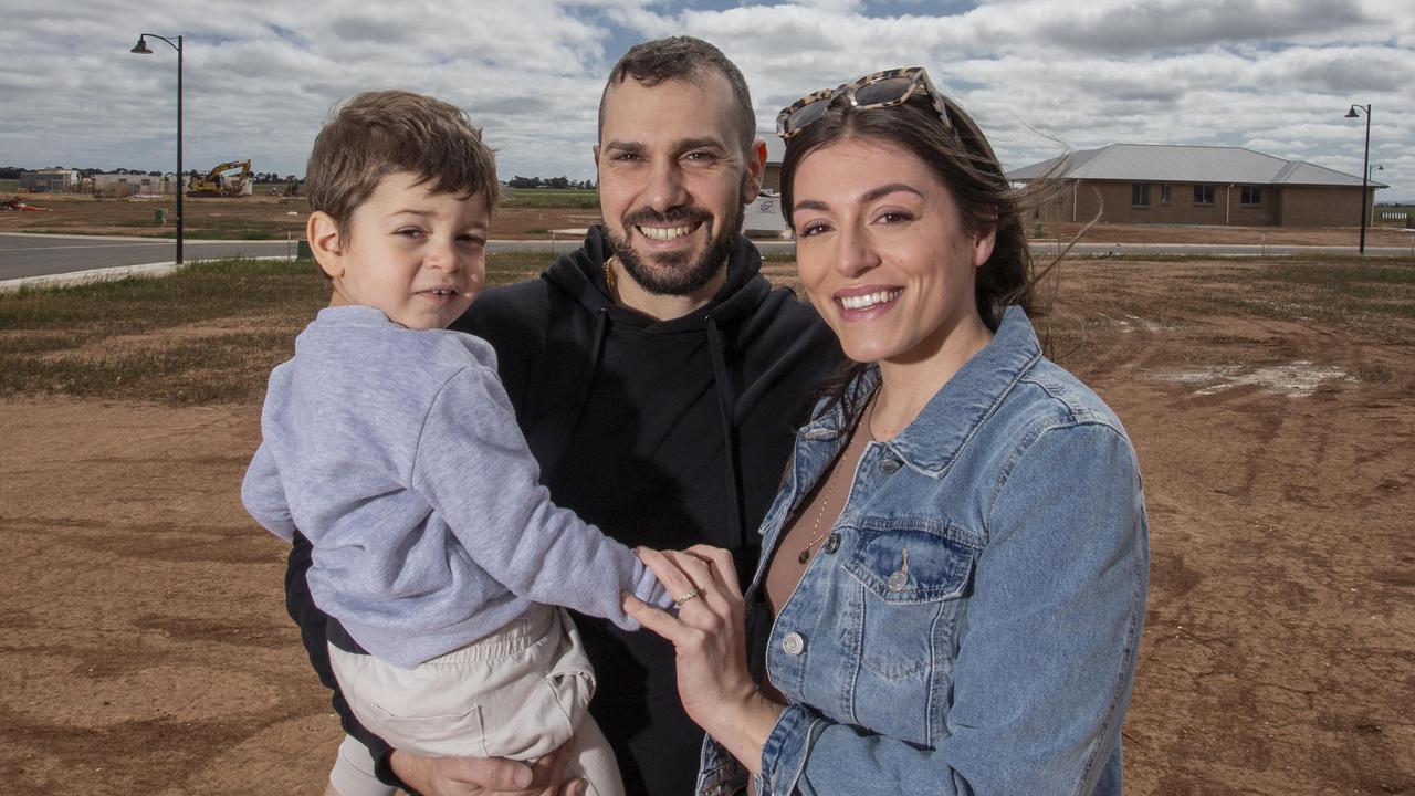 Marco Panucci and Sheridan Clarke with son Luca at their block in Two Wells – the northern suburbs is identified as a key growth area for housing. Picture: Brett Hartwig