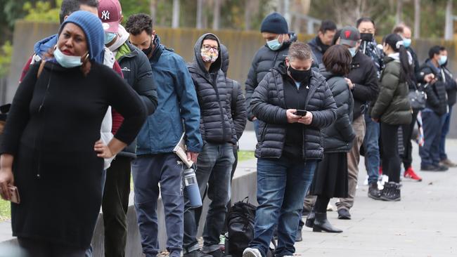 People line up for vaccinations at the Royal Exhibition Building in Carlton. Picture: David Crosling