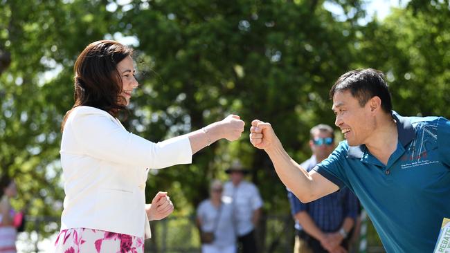 Queensland Premier Annastacia Palaszczuk fist-bumps with a voter at a polling booth at Aspley State School on Saturday. Picture: NCA NewsWire / Dan Peled