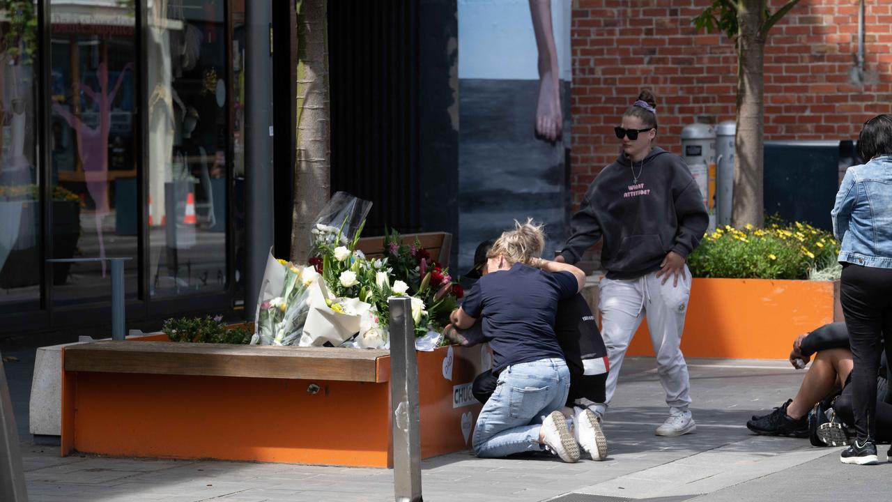 Family and friends at the scene in Little Malop St. Picture Brad Fleet