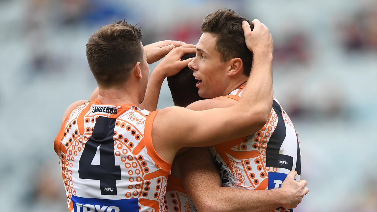 Josh Kelly and Tim Kelly celebrate a goal with Brent Daniels on Sunday.