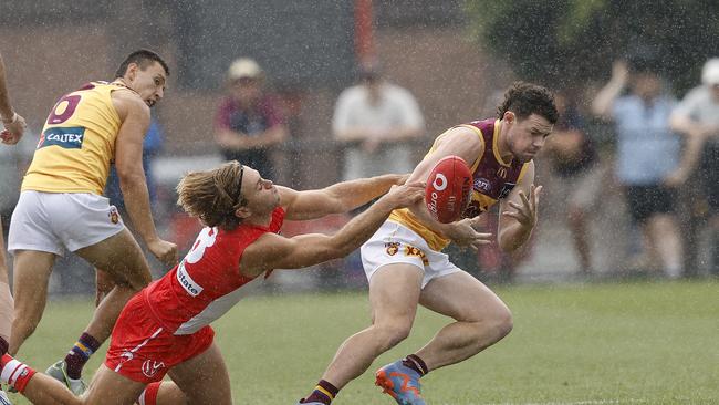 Brisbane's Lachie Neale (right is grabbed by Sydney's James Rowbottom. Picture: Phil Hillyard