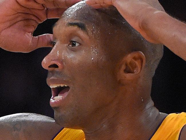 Los Angeles Lakers guard Kobe Bryant reacts after he was called for traveling during the second half of an NBA basketball game Phoenix Suns, Tuesday, Nov. 4, 2014, in Los Angeles. The Suns won 112-106. (AP Photo/Mark J. Terrill)