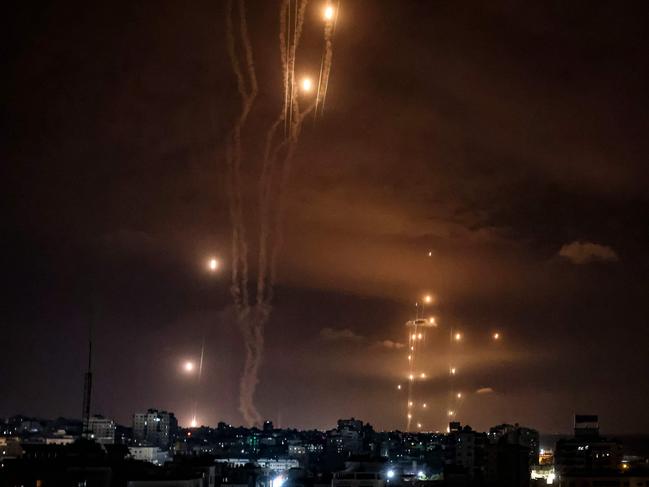 Rockets fired by Palestinian militants from Gaza City are intercepted by the Israeli Iron Dome. Picture: AFP