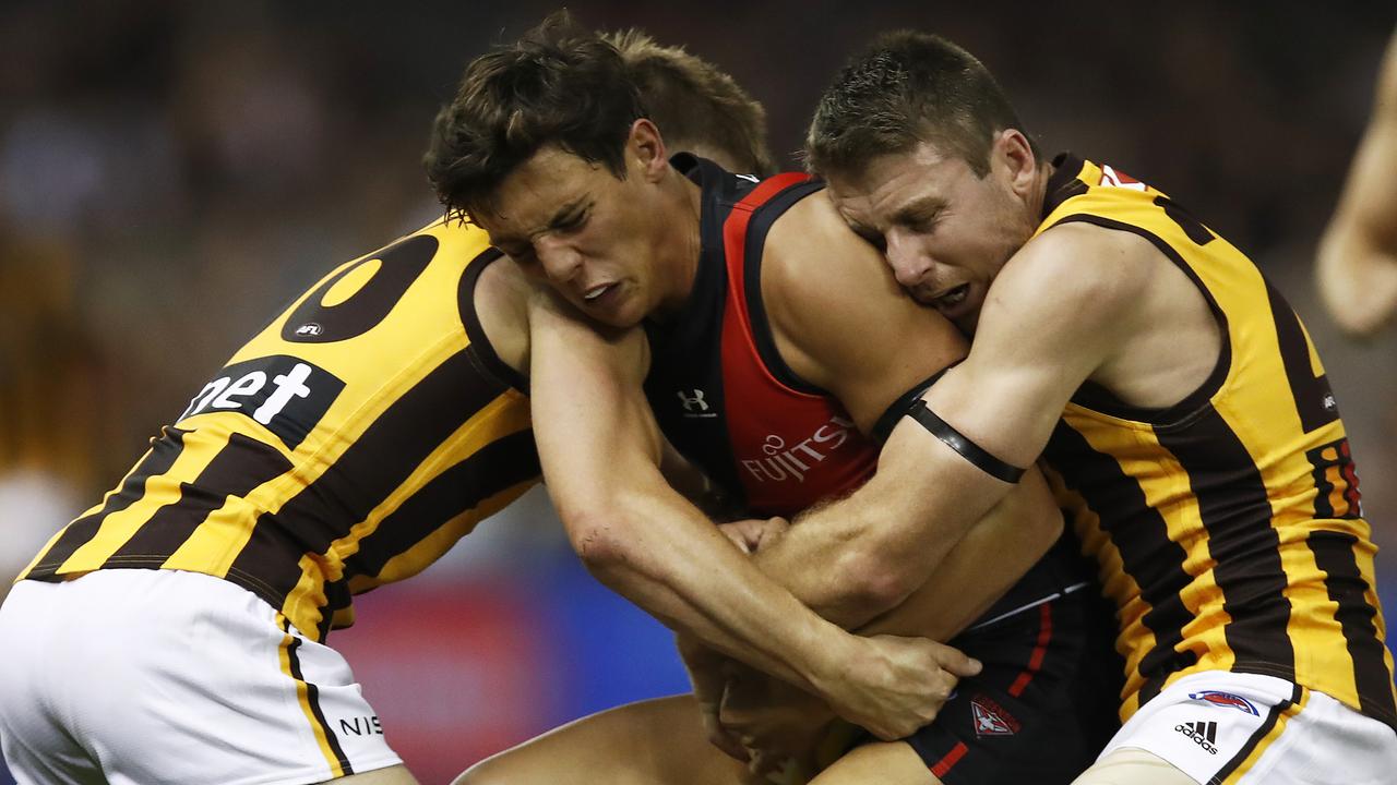 Jye Caldwell of the Bombers is tackled by Liam Shiels and Dylan Moore.