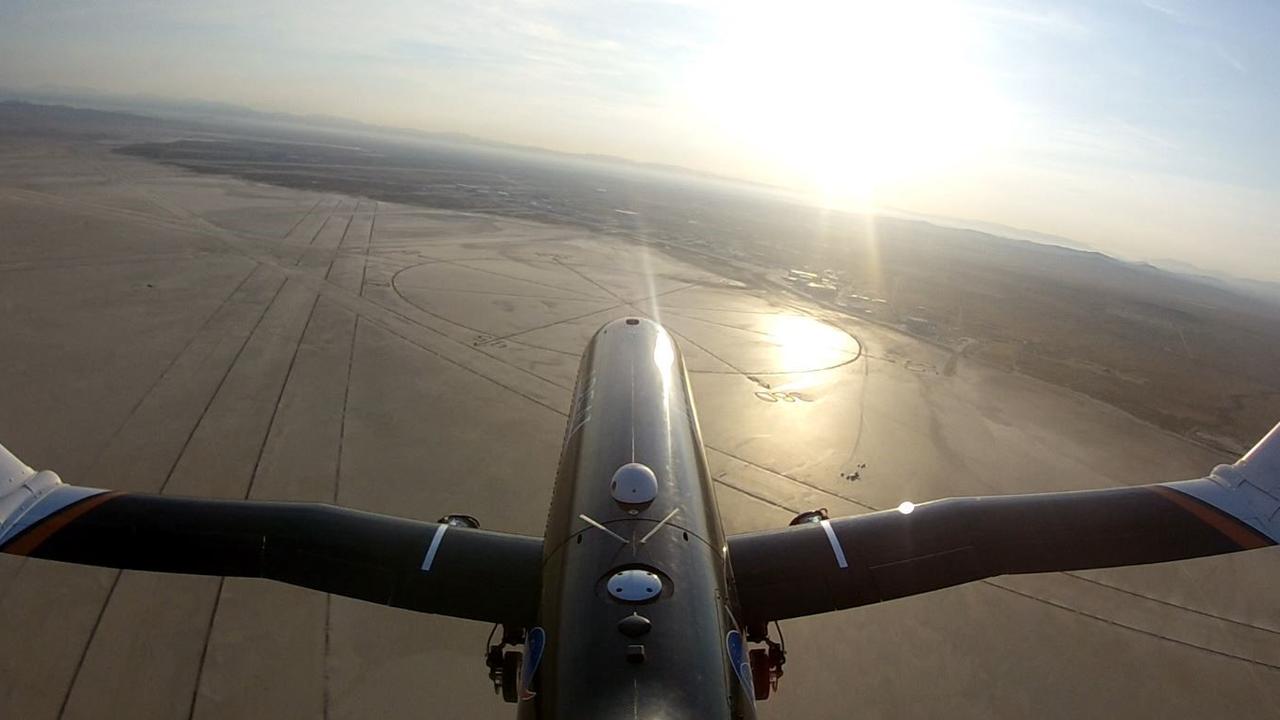 The testbed PTERA flies with the outer portions of its wings folded 70 degrees upwards. The aircraft took off with its wings at zero degrees deflection, keeping them level during takeoff. The wings were folded during the flight using a thermally-triggered shape memory alloy. Credits: NASA/Area-I Inc.