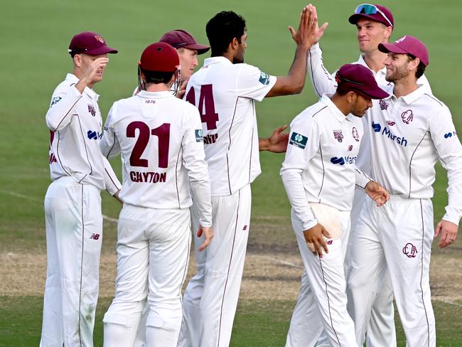 BRISBANE, AUSTRALIA - OCTOBER 08: Gurinder Sandhu of Queensland celebrates taking the wicket of Riley Meredith of Tasmania as Queensland claims victory during the Sheffield Shield match between Queensland and Tasmania at Allan Border Field, on October 08, 2022, in Brisbane, Australia. (Photo by Bradley Kanaris/Getty Images)