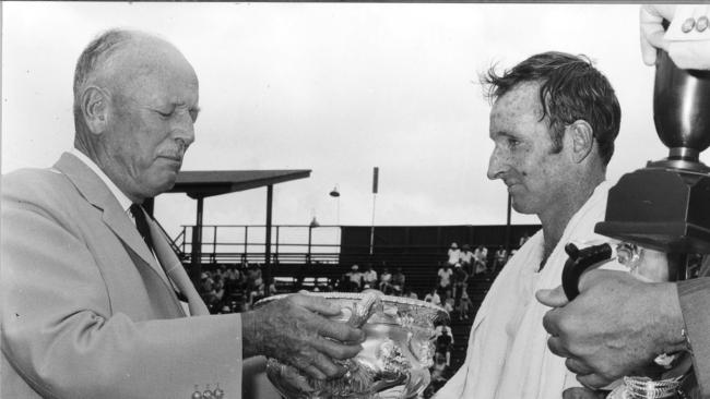 Rod Laver receives trophy after winning the 1969 Australian Open epic in Brisbane. Picture: Supplied