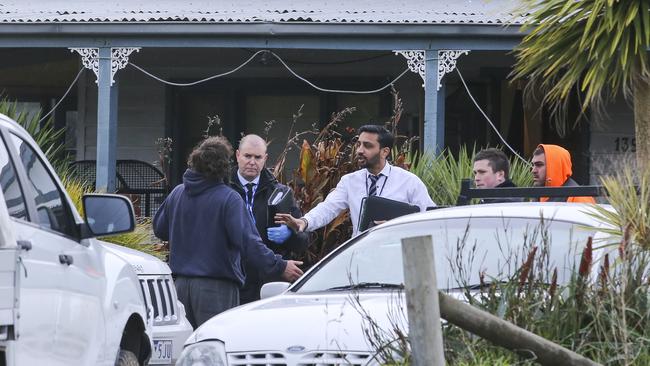 Detectives speak with people at the scene of a shooting in Baxter. Picture: Wayne Taylor