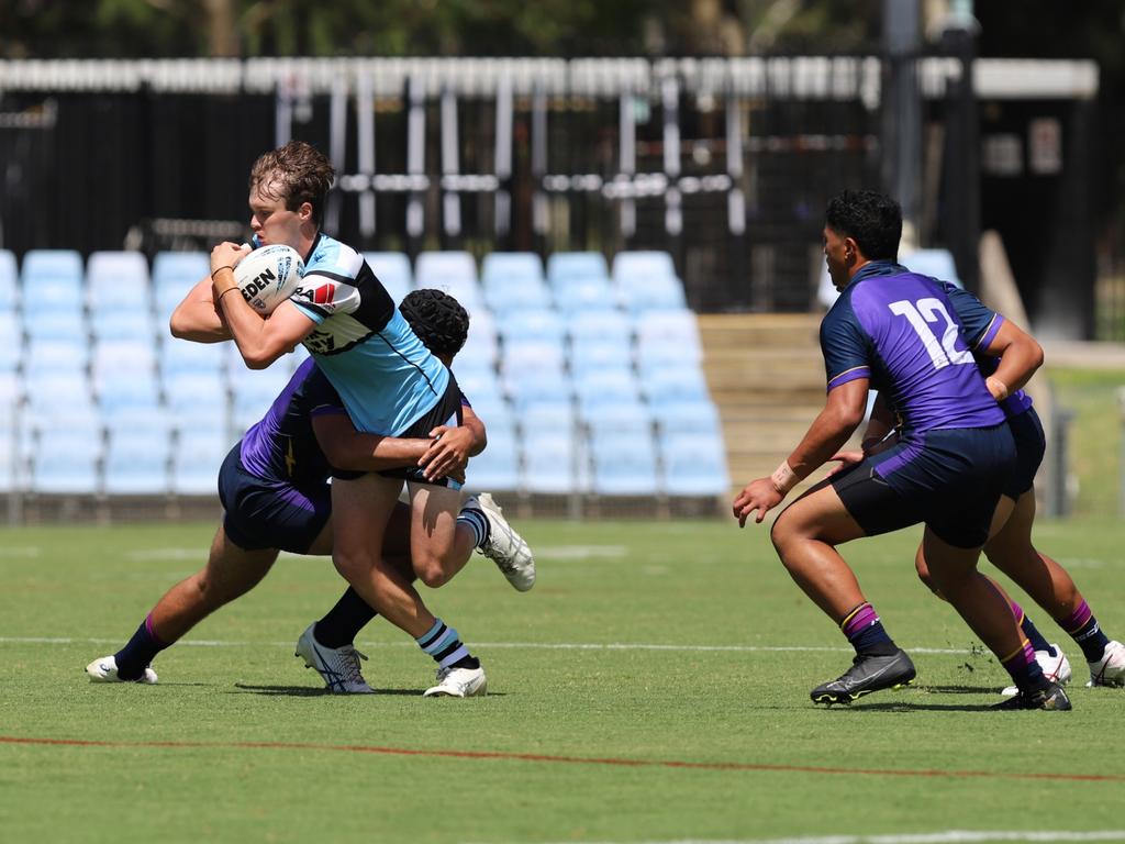 Jett Forbes is tackled by Ioane Lui. Picture: Steve Montgomery/Ourfootyteam.com