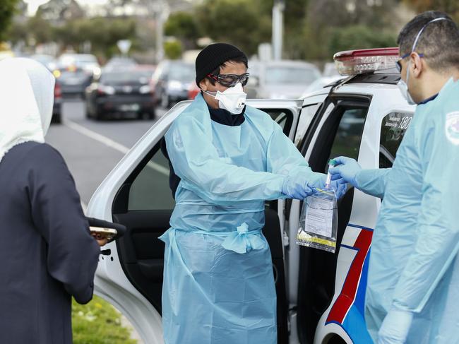 Paramedics perform COVID19 tests in Broadmeadows after Victoria State Government Health and Human Services people knock on doors to check if people have any symptoms. Picture: AAP