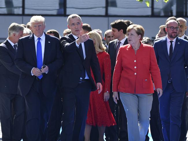 U.S. President Donald Trump, left, NATO Secretary General Jens Stoltenberg and German Chancellor Angela Merkel walk through NATO headquarters at the NATO summit in Brussels. Picture: AP