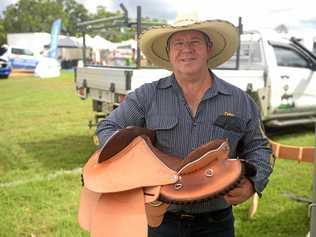 Dallas Dixon donates a saddle to the Paradise Lagoons auction to raise money for rural rescue services. Picture: Jann Houley