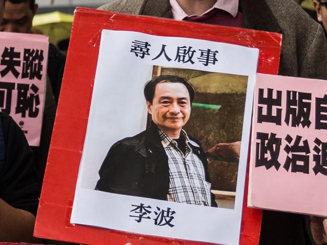 In this picture taken on January 3, 2016, a protester holds up a missing person notice for Lee Bo, 65, the latest of five Hong Kong booksellers from the same Mighty Current publishing house to go missing. (AFP/anthony Wallace)