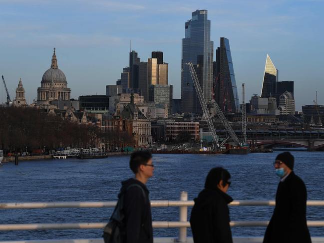 The skyline of the City of London is seen in the evening sunlight on December 17, 2020. - Stock markets mostly gained Thursday as investors kept an eye on US stimulus progress and the rollout of vaccines but surging infections and new lockdowns tempered gains. The pound held around 19-month highs against the dollar as the Bank of England held fire over interest rates and stimulus as Britain and the EU continue their 11th-hour talks on their post-Brexit trading arrangement. (Photo by DANIEL LEAL-OLIVAS / AFP)