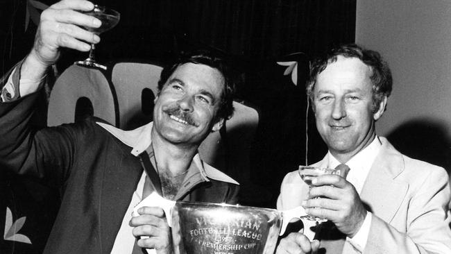 Ron Barassi and North Melbourne president Lloyd Holyoak with the 1977 premiership cup.