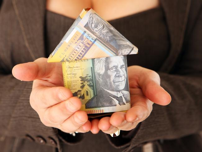 Business woman isolated on a white background holding a money house. property investing Australia generic