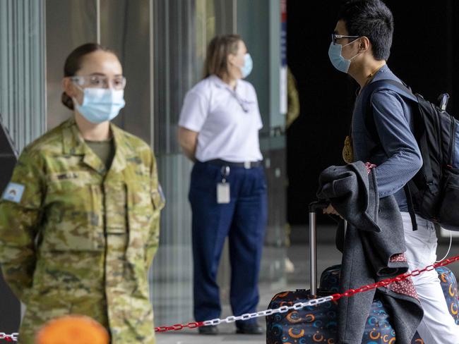 MELBOURNE , AUSTRALIA - NewsWire Photos DECEMBER 08 , 2020  ; Returning Australian travellers file off a Skybus at The Pan Pacific Hotel along South Wharf which is one of the quarantine hotels due to COVID-19. Picture : NCA NewsWire / Ian Currie