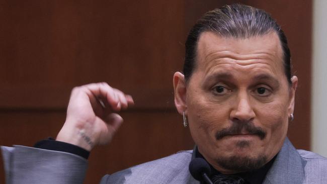 Depp smirked while listening to his ex-wife’s testimony. Picture: AFP