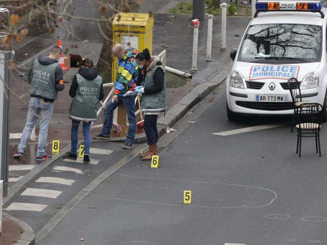 Police forensics experts examine the scene where a female police officer was shot dead in Montrouge, a southern suburb of Paris. Picture: Kenzo Triboiullard