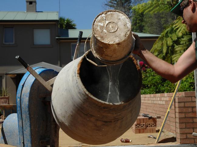 A bricklayer prepares cement on the construction site of a residential  home in Sydney, Australia, on Wednesday, Oct. 3, 2007. Australia's economic growth probably edged up in the third quarter, driven by accelerating consumer spending and increased construction. Photographer: Jeremy Piper/Bloomberg News