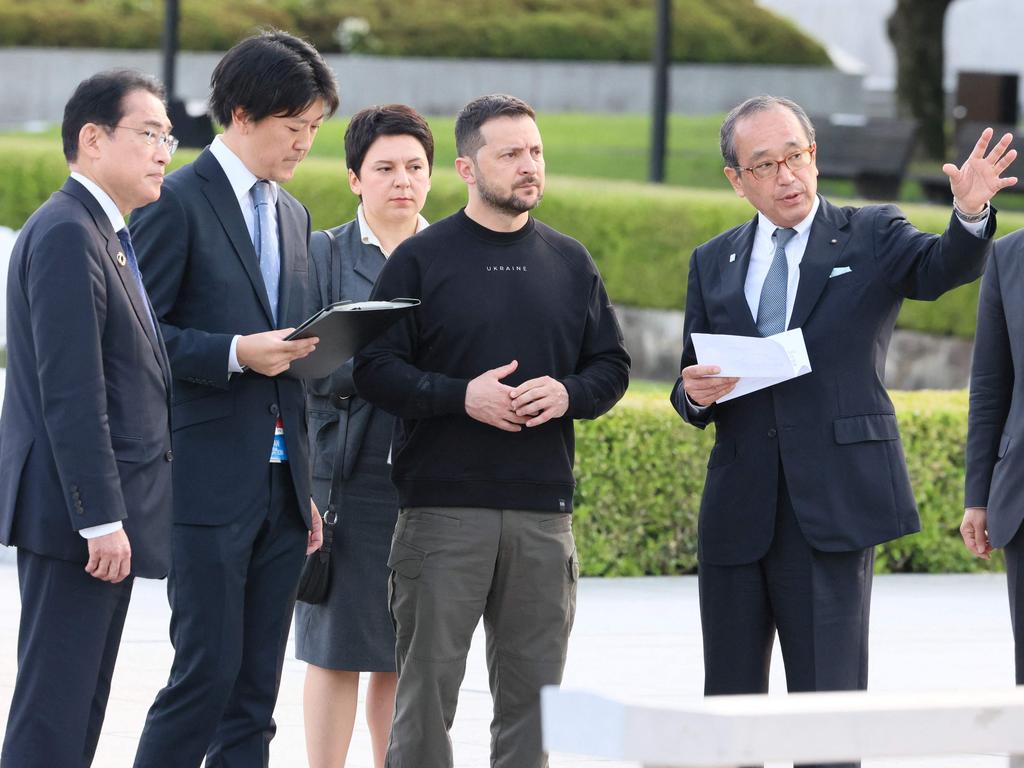 Japan's Prime Minister Fumio Kishida (L) and Ukraine's President Volodymyr Zelenskyy (C) during a visit to the Cenotaph for the Victims of the Atomic Bom. Picture: AFP