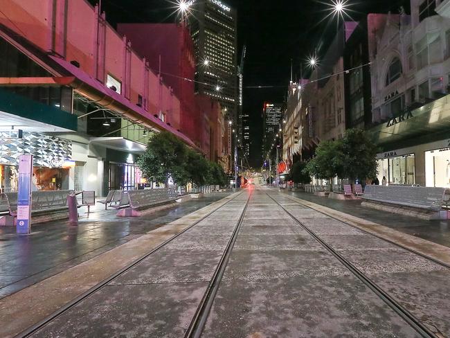 Melbourne's CBD is very quiet for a Friday night as the city experiences a spike in coronavirus cases and more than 30 suburbs are forced into lockdown. A deserted Bourke Street Mall. Picture : Ian Currie