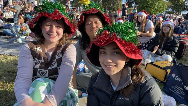 Templestowe friends Marguerite, Amy and Andy at Manningham's 2022 Carols.