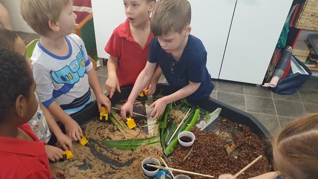 Kindergarten students at Child’s World BP4 play at the sensory table while during a World Earth Day activity. Photo: supplied.