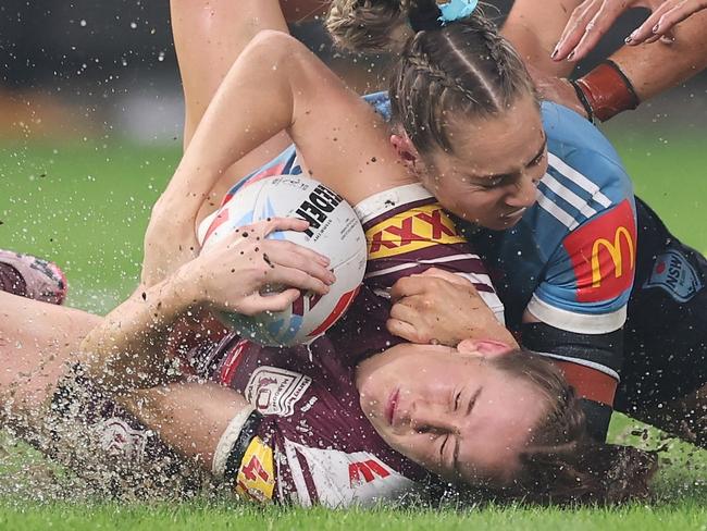 SYDNEY, AUSTRALIA - MAY 15: Tamika Upton of the Maroons is tackled by Kezie Apps of the Bluesduring game two of the Women's State of Origin series between the New South Wales Blues and Queensland Maroons at Allianz Stadium on May 15, 2025 in Sydney, Australia. (Photo by Cameron Spencer/Getty Images)