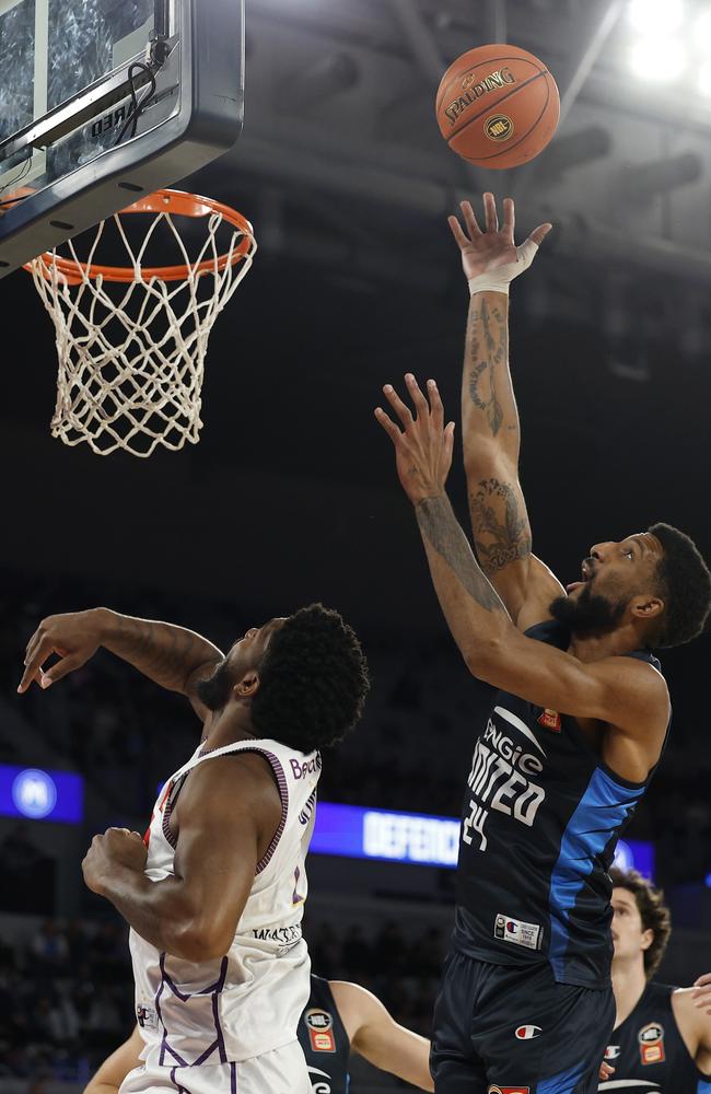 Melbourne United’s Marcus Lee gets up high to rebound the ball. Picture: Getty Images