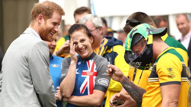 Prince Harry meets Australian athlete Ben Yeomans as he wears a pair of Budgy Smugglers on his head during the Invictus Games Cycling at the Royal Botanical Gardens. Picture: Getty Images