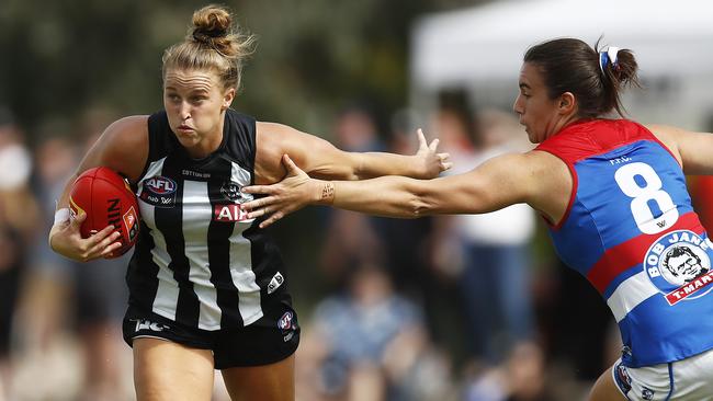 Ruby Schleicher breaks a tackle from Bonnie Toogood.