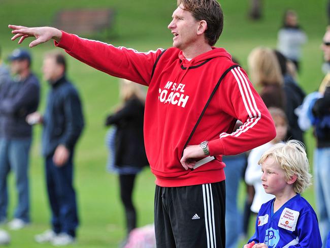 James Hird coaching his son Tom when he was nine years old. 