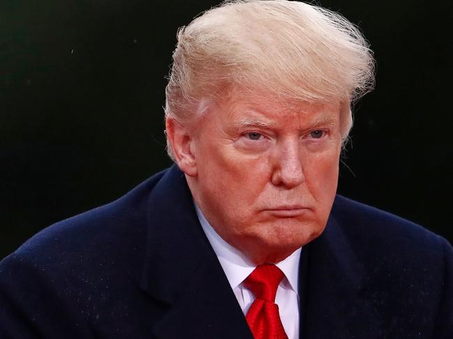 TOPSHOT - US President Donald Trump looks on as he visits the American Cemetery of Suresnes, outside Paris, on November 11, 2018 as part of Veterans Day and the commemorations marking the 100th anniversary of the 11 November 1918 armistice, ending World War I. (Photo by CHRISTIAN HARTMANN / POOL / AFP)