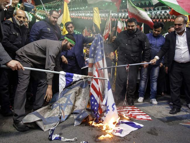 Iranians burn Israeli and US flags during a protest at Palestine square in Tehran, on April 1, 2024. Israeli air strikes destroyed the Iranian embassy's consular annex in Damascus on April 1, Syrian and Iranian officials said, with a top Revolutionary Guard commander among eight reported to have been killed amid worsening regional tensions. (Photo by AFP)