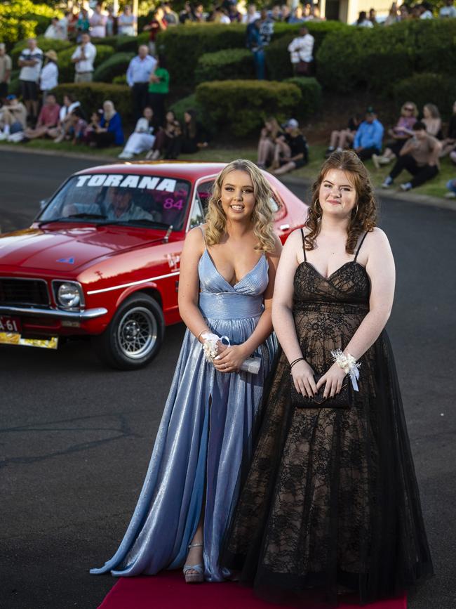 Mia Facer (left) and Abby Pidgeon arrive at Harristown State High School formal at Highfields Cultural Centre, Friday, November 18, 2022. Picture: Kevin Farmer