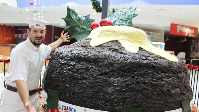 John Stevenson with a 1.3 tonne Christmas pudding he made to bring back the Christmas spirit to his home town after Dubbo was hit with devastating floods in 2010.