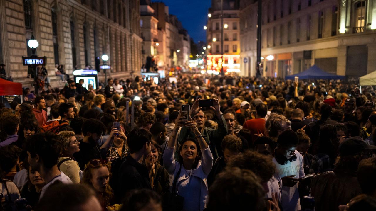 People celebrate during an election night rally following the first results of the second round of France's legislative election at Republique Square in Paris. Picture: Olympia De Maismont / AFP