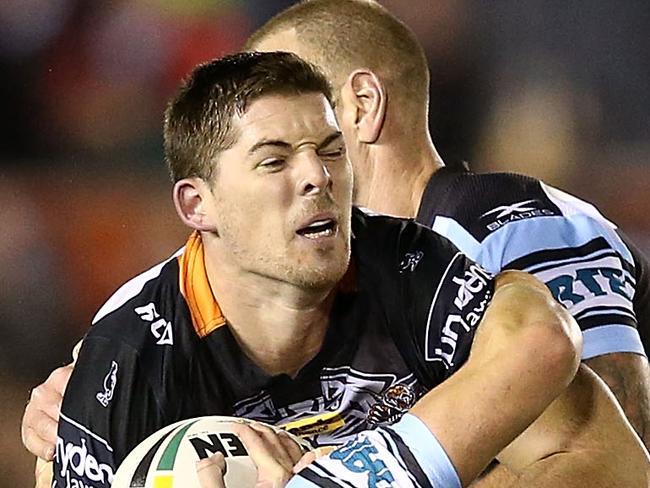 SYDNEY, AUSTRALIA - JUNE 17:  Matt Eisenhuth of the Tigers is tackled during the round 15 NRL match between the Cronulla Sharks and the Wests Tigers at Southern Cross Group Stadium on June 17, 2017 in Sydney, Australia.  (Photo by Mark Metcalfe/Getty Images)