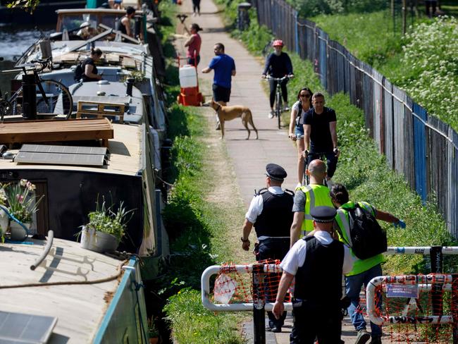 Police officers patrol along the Hertford Union Canal in east London. Picture: AFP