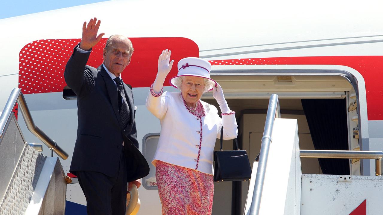 The Queen and Prince Philip wave goodbye as they board their flight home in Perth in 2011 – it was her final visit to Australia. Picture: Lincoln Baker / POOL / AFP