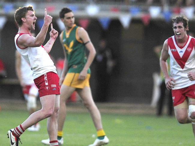 Federals player Chris Cooper celebrates a goal against Pioneer during the Pioneer grand final at Traeger Park oval