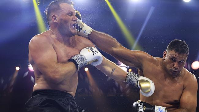 Justin Hodges lands a punch on Nathan Ross. Photo by Mark Evans/Getty Images