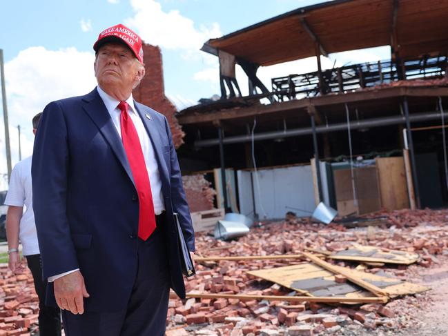 ATLANTA, GEORGIA - SEPTEMBER 30: Republican presidential nominee, former U.S. President Donald Trump, listens to a question as he visits Chez What Furniture Store which was damaged during Hurricane Helene on September 30, 2024 in Valdosta, Georgia. Trump met with local officials, first responders, and residents who have been impacted by last week's hurricane which has left at least 90 people dead across Florida, Georgia, North Carolina, South Carolina, and Virginia. Millions are still without power, water, or reliable communications. U.S. President Joe Biden and Democratic presidential nominee, U.S. Vice President Kamala Harris have spoken with local leaders and stated that they plan to visit affected areas when the time is right.   Michael M. Santiago/Getty Images/AFP (Photo by Michael M. Santiago / GETTY IMAGES NORTH AMERICA / Getty Images via AFP)