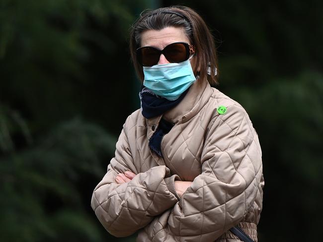 Disposable surgical masks should be thrown out once they become damp. Picture: Getty Images