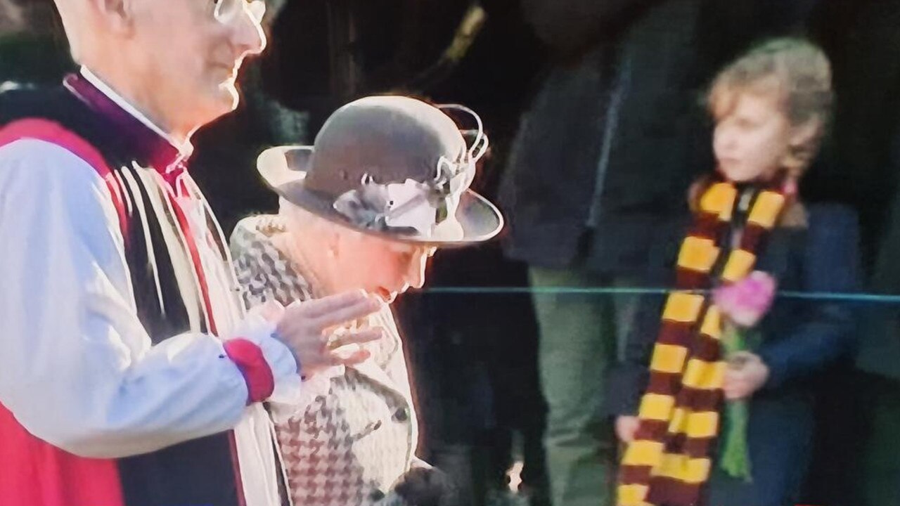 In the background of this shot of the Queen is a keen Hawks fan ... well, according to Jeff Kennett.