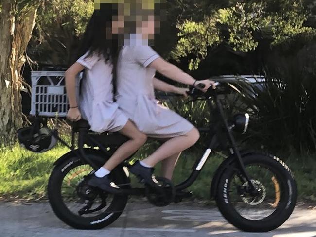 Secondary school students on an e-bike on a shared path in Manly, without helmets, where locals have been complaining about bikes speeding along footpaths at up to 30km/h. Picture: Jim O'Rourke