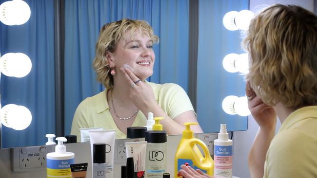 Grace Baldwin applying sunscreen and skincare producs from Coles to help protect her skin. Picture: David Caird