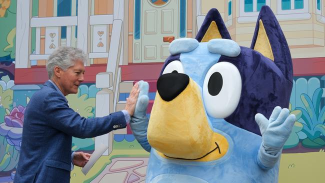 Australia's top dog in London, Stephen Smith, high-fives Australia's most famous blue-heeler, Bluey, outside the Australian High Commission in London. Photo: Jacquelin Magnay